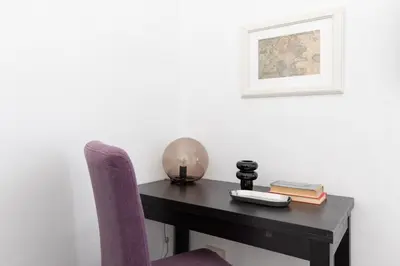 a desk with a purple chair and a picture at iFlat Colosseum Comfy House in Rome