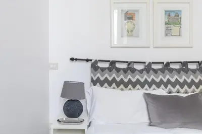 a bedroom with a bed with a black and white headboard at iFlat Colosseum Comfy House in Rome