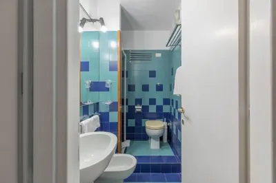 a bathroom with a toilet and a sink at iFlat Colosseum Comfy House in Rome