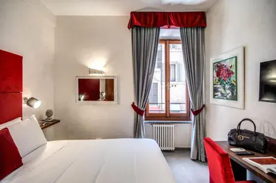 a bedroom with a white bed and a window at Tritone Top House in Rome