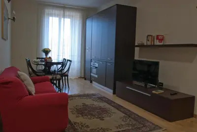 a living room with a red couch and a table at Le Cupoline in Rome