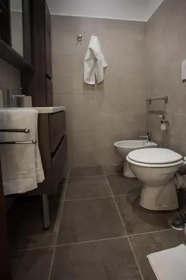 a bathroom with a toilet and a sink at Le Cupoline in Rome
