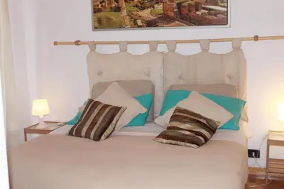 a bedroom with a bed with two pillows on it at Daffodil in Roma San Pietro in Rome