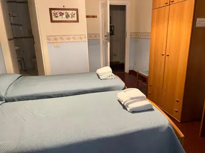 two beds in a room with towels on them at B&B San Michele a Porta Pia in Rome