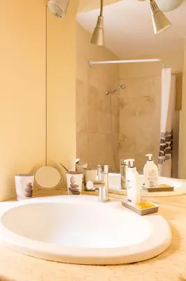 a bathroom with a large white sink and a shower at Savelli Apartment in Rome