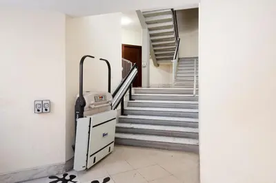 a hallway with stairs and a suitcase in a building at G&C house in Rome