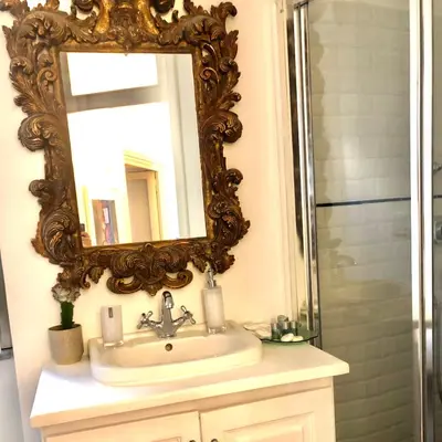 a bathroom with a sink and a mirror at Snooze Trastevere House in Rome