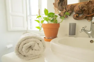a towel sitting on a bathroom counter next to a sink at Snooze Trastevere House in Rome