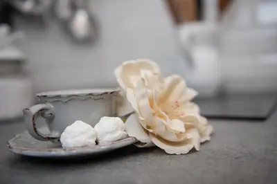 a plate with a cup and a flower on a table at Sweet Arco Farnese in Rome