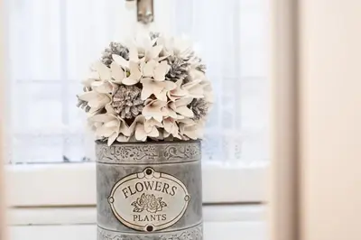 a can with flowers in it sitting in a window at Sweet Arco Farnese in Rome