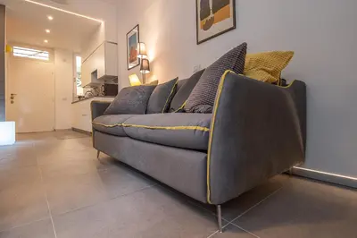 a blue couch sitting in a living room at Cosy studio in the greenest corner of Trastevere in Rome