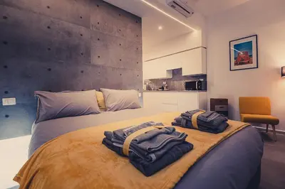 a bedroom with a large bed with towels on it at Cosy studio in the greenest corner of Trastevere in Rome