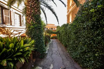 an alley with a palm tree and a bunch of bananas at Cosy studio in the greenest corner of Trastevere in Rome