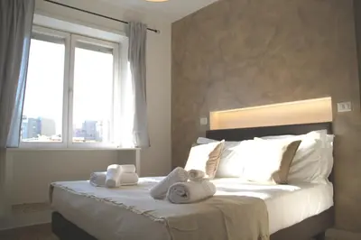 a bedroom with a large bed with towels on it at B&B Pigneto7 in Rome