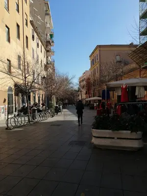 a person walking down a city street with buildings at B&B Pigneto7 in Rome