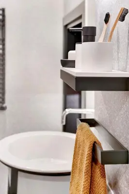 a bathroom with a sink and a table with a towel at Luxury Trevi House in Rome