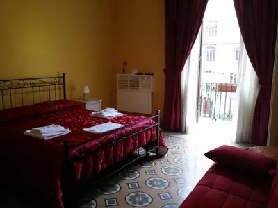 a bedroom with a red bed and a window at La Breccia A Porta Pia in Rome