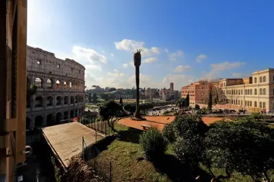 a view of a city with a building and a palm tree at ROMANCE AL COLOSSEO 2 in Rome