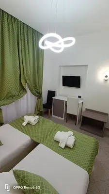 a living room with two beds and a television at House 4 Mori in Rome