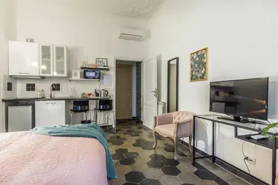 a living room with a bed and a kitchen at Appartamento Flora Metro Vittorio in Rome