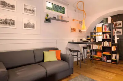 a living room with a couch and a table at Lata Rana Colosseum Luxury Loft in Rome
