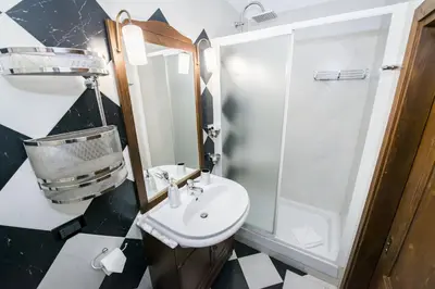 a bathroom with a sink and a shower at Vicolo dell'Aquila - Residenze Romanae in Rome