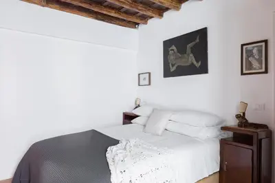 a bedroom with white walls and a white bed at Classic and chic apartments in Trastevere in Rome