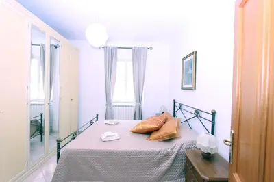a bedroom with a bed with two pillows on it at Torrigio Flat in Rome