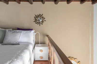 a bedroom with a bed and a clock on the wall at iFlat Pantheon Historic Two-Story Apartment in Rome