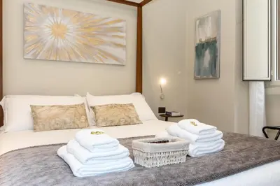 a bedroom with a bed with white towels on it at Suites 44 - Guesthouse close to Vaticano, San Pietro, Castel Sant'angelo in Rome
