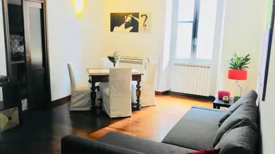 a living room with a couch and a table at Comfort spazio e privacy 2 camere 2 bagni e self check in nel cuore di San Giovanni in Rome