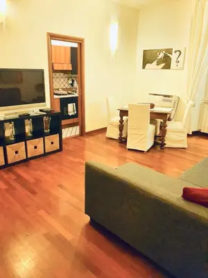 a living room with a couch and a piano at Comfort spazio e privacy 2 camere 2 bagni e self check in nel cuore di San Giovanni in Rome