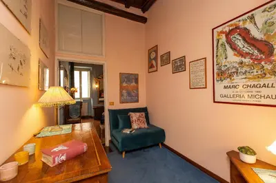 a living room with a green chair and a table at The Dreamers House in Rome