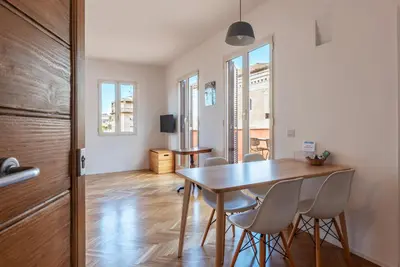 a dining room with a table and chairs at Apartment with Terrace in via del Pellegrino - FromHometoRome in Rome