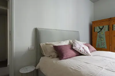 a bed with two pillows on top of it at Casa Satrico in Rome