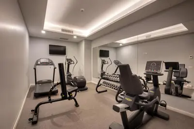 a gym with several exercise bikes and treadmills at Hotel St Martin by OMNIA hotels in Rome