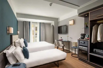 a hotel room with a bed and a table at Hotel St Martin by OMNIA hotels in Rome