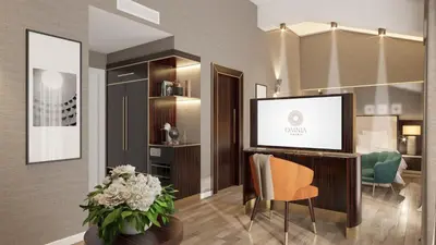 a living room with a tv and a table with flowers at Hotel St Martin by OMNIA hotels in Rome