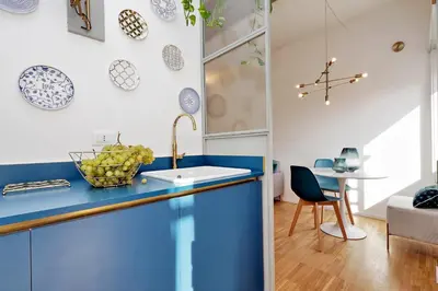 a kitchen with a blue counter top and a table at RENOVATED AND COZY FLAT in Rome