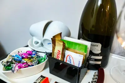 a bottle of wine and a container of candy at Lydka Domus in Rome