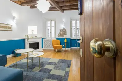 a room with a door and a living room with blue at Boutique Apartment Pantheon in Rome