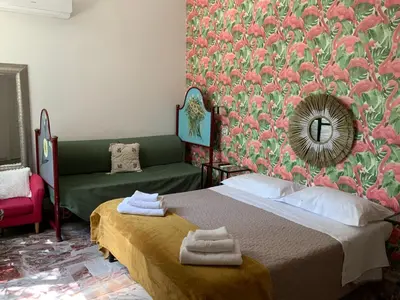 a bedroom with a bed and a green couch at Vatican Fairytale Garden in Rome