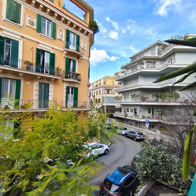 a city street with cars parked in front of buildings at Ada Home in Rome