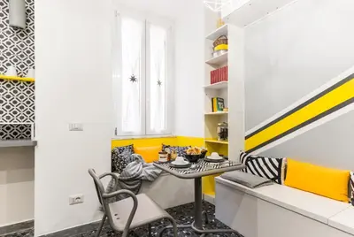 a dining room with a table and yellow accents at Benincasa Bed&Breakfast in Rome