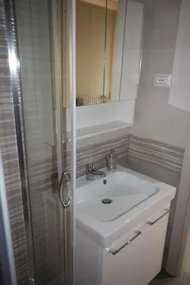 a white washer and dryer in a room at Roman Art Apartment - Metro C to Colosseum in Rome