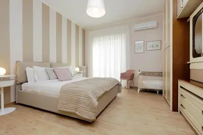 a bedroom with a bed and a television in it at Elegant 3-Bed Apartment 10' Termini Wi-Fi AC in Rome