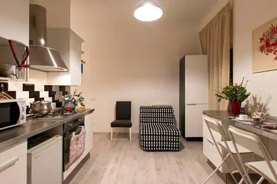 a kitchen with a refrigerator and a counter top at DOMUS FORTUNAE VATICANO in Rome