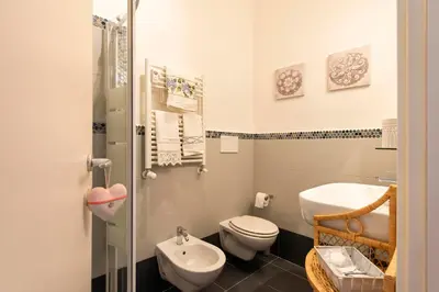 a small bathroom with a toilet and a sink at DOMUS FORTUNAE VATICANO in Rome