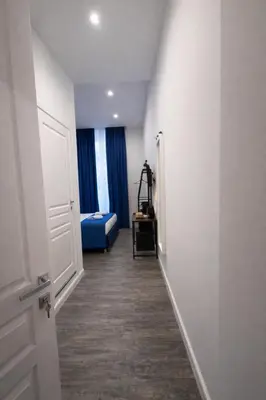 a hallway with a room with a bed and a door at IHH COLLECTION - Eden Luxury Roma in Rome
