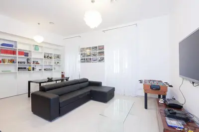 a living room with a black couch and a table at SvHome in Rome